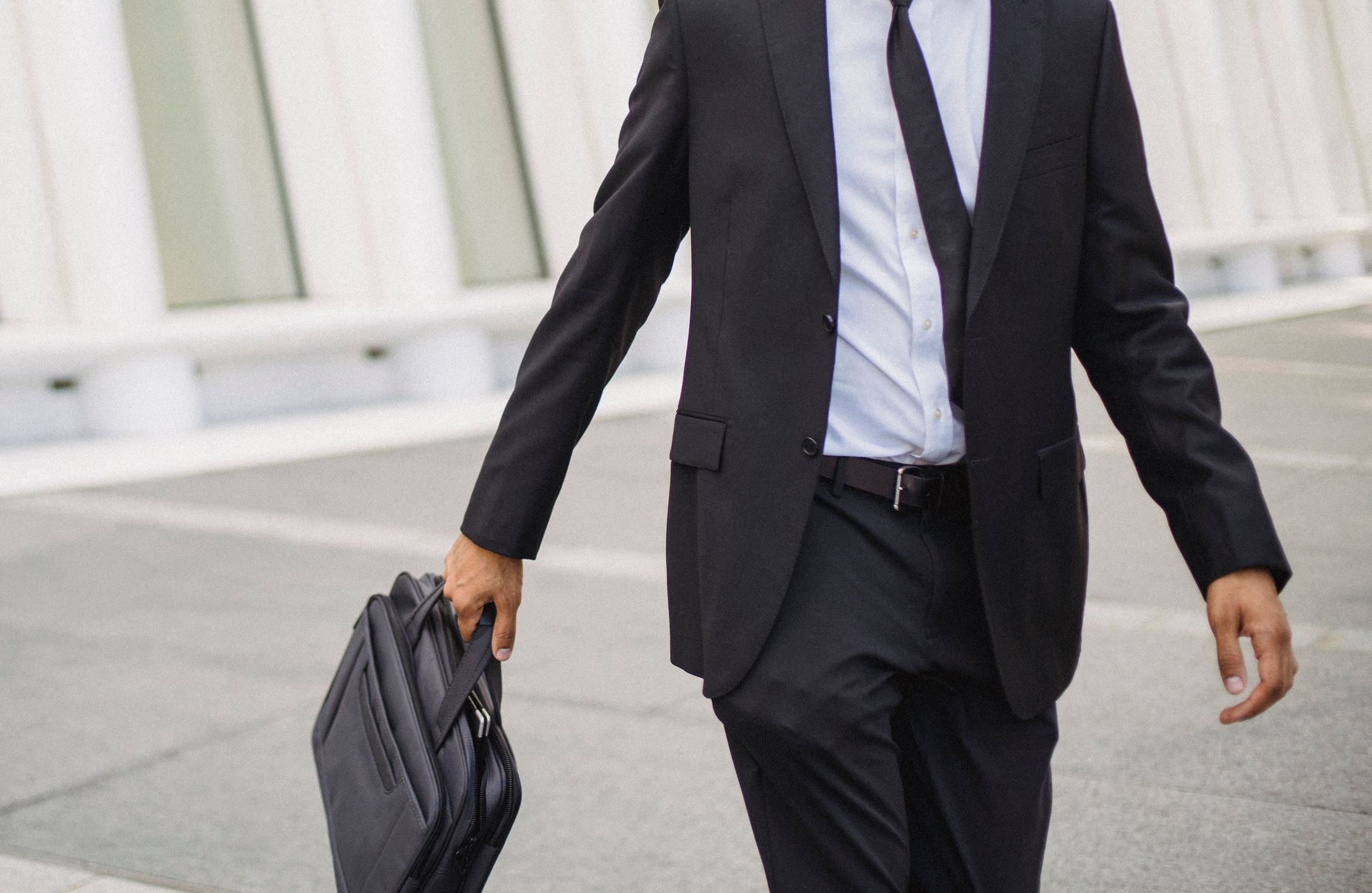 Walking to work, briefcase in hand