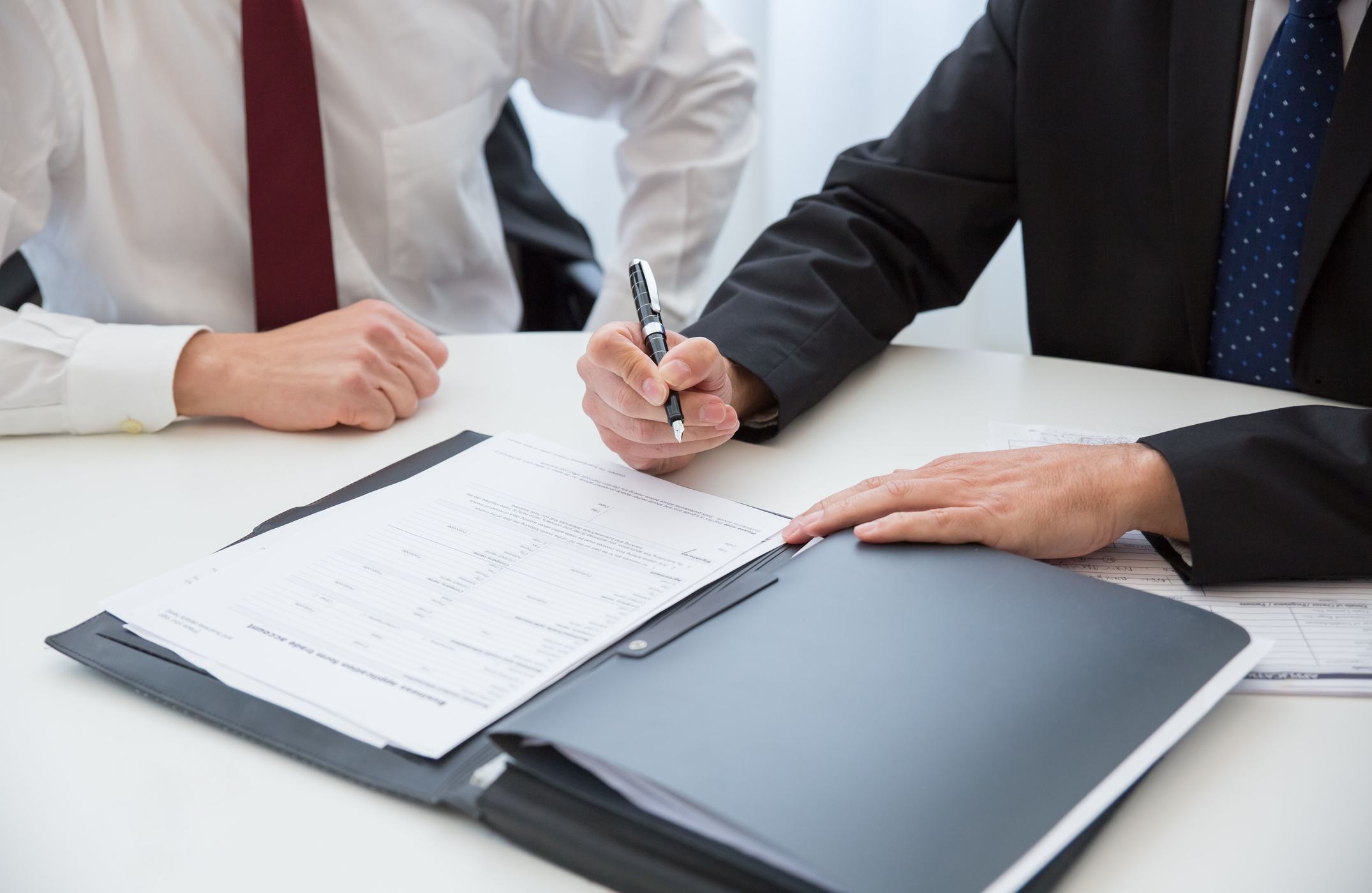 Signing a return across a desk