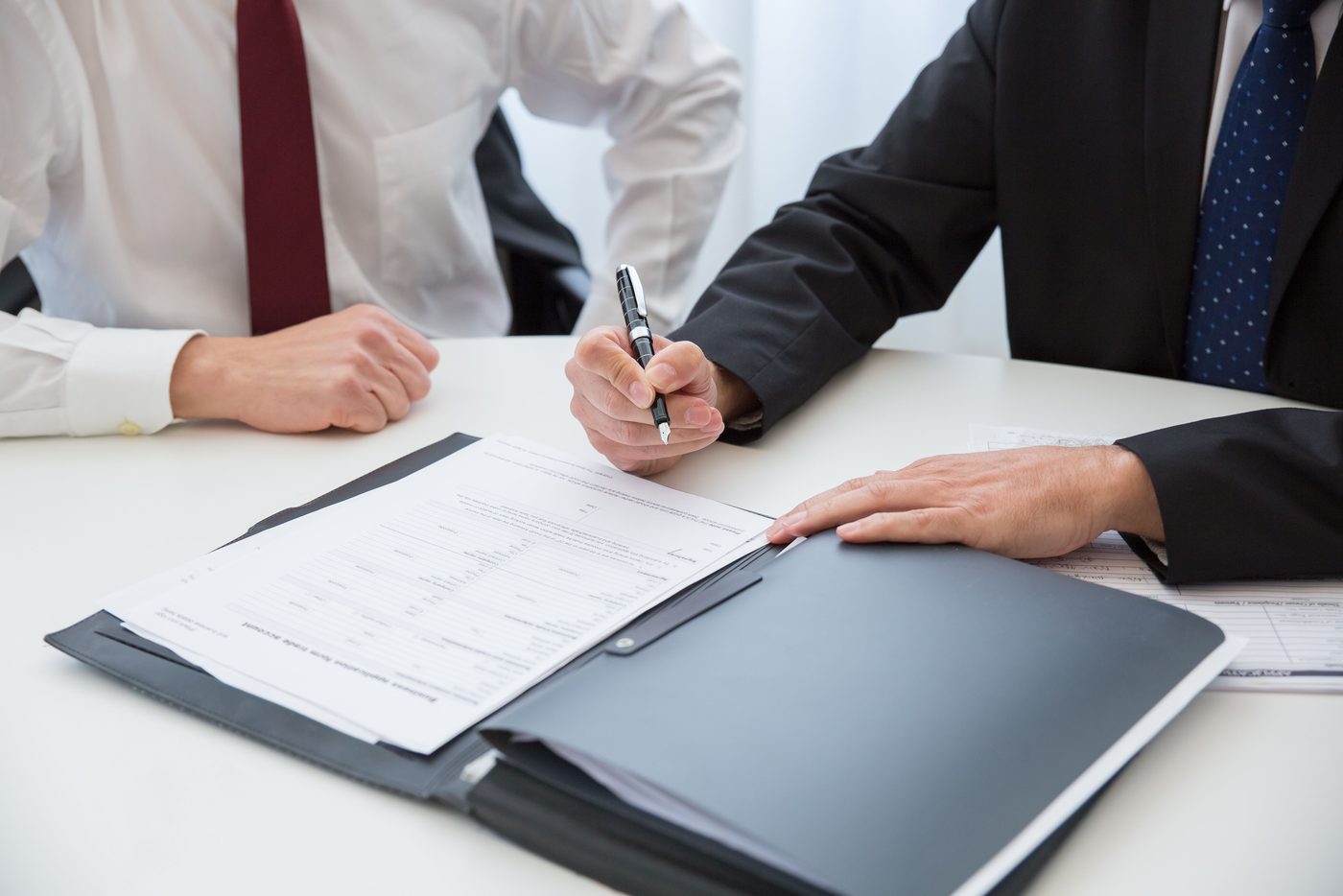 Signing a return across a desk